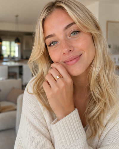 Woman wearing a COLMI R02 smart ring with neutral knitwear at home