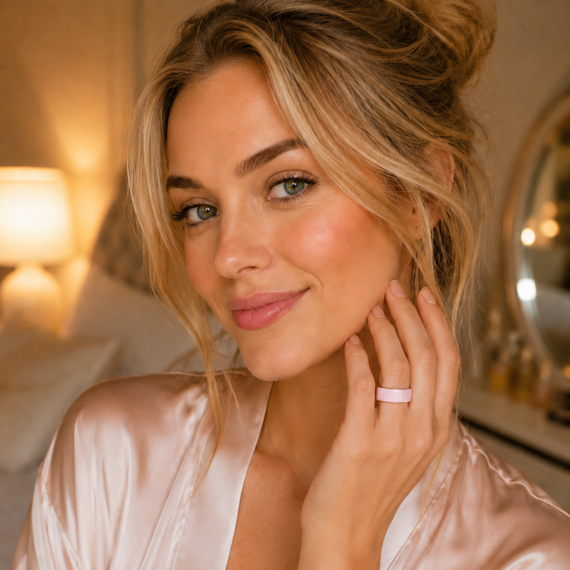 Woman wearing a pink ceramic COLMI Ring 2 smart ring indoors