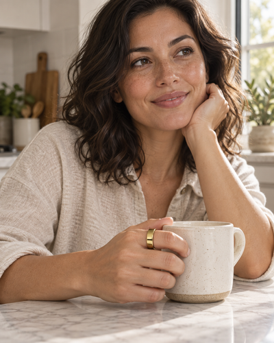 COLMI Ring 2 Pro in Gold worn on an index finger during a morning at home
